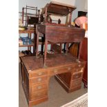 A late 19th century oak kneehole pedestal desk, leather inset, arrangement of nine drawers, plinth