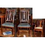 A pair of Edwardian mahogany Art Nouveau style chairs with carved heart motifs and peacock print