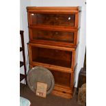 An oak Globe Wernicke stacking waterfall bookcase, the moulded top above four tiers and base with