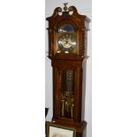 A Kieninger strike-silent oak cased longcase clock, the arched dial with silvered chapter ring, 53cm