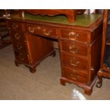 A 20th century mahogany twin-pedestal desk, green leather inset, arrangement of nine drawers,