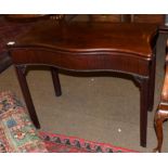 A George III mahogany serpentine shape foldover card table, circa 1780, enclosing a green baize