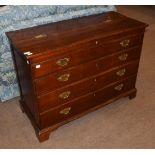 A George III oak chest of four drawers, top two dummy, hinged lid, brass swan neck handles,