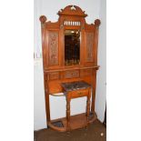 An Edwardian oak hall stand, central bevelled glass mirror, marble shelf and single drawer, 99cm