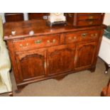 An 18th century oak enclosed low dresser, moulded rectangular top, two drawers, brass swan neck