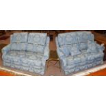 A pair of blue upholstered two-seater wing backed sofas, 155cm by 100cm by 88cm high