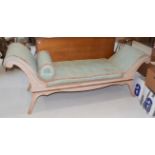 A 20th century double scroll-ended day-bed with gold and teal upholstered and a bleached wood frame,