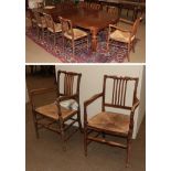 A set of twelve oak country chairs including three carvers, each with rush seats (12) . Is a set all