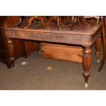 An early 19th century oak writing table with red leather inset, twin drawers, reeded baluster legs