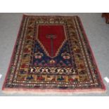 An Anatolian Prayer rug, The crimson field beneath the Mihrab enclosed by multiple borders, 184cm by