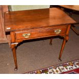 An 18th century oak side table, rectangular top above single drawer, brass swan neck handles, turned