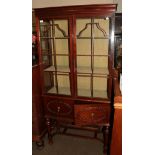 An Edwardian mahogany display cabinet in the 18th century style, two glazed doors over twin cupboard