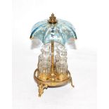 A set of four glass scent bottles, in brass mounted stand with overhead enamelled blue glass