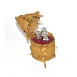 A set of three scent bottles, in fitted brass box formed as a skep, on twisted wire feet and with