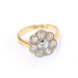 A diamond cluster ring, the central round brilliant cut diamond within a border of smaller old cut