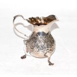 A George II silver cream jug, by Isaac Cookson, Newcastle, 1751, pear-shaped and on three pad