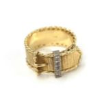 A diamond belt and buckle ring, the yellow textured band with a reeded edge and a buckle motif