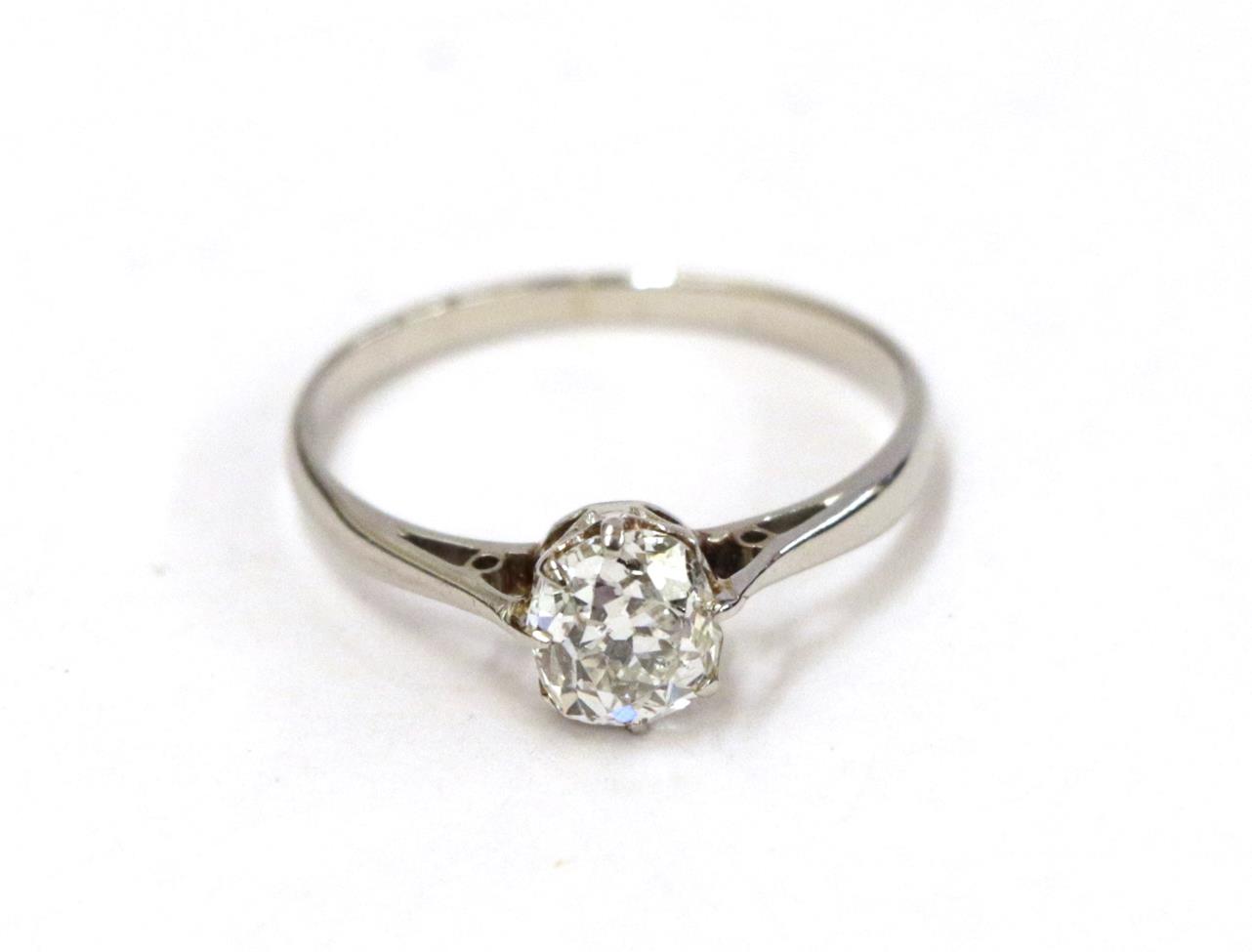 A diamond solitaire ring, the old cut diamond in a white claw setting, to a tapered shoulder plain