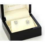 A pair of diamond cluster earrings, four princess cut diamonds in white claw settings, total