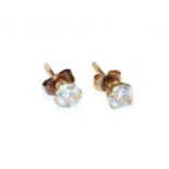 A pair of diamond solitaire earrings, the round brilliant cut diamonds in yellow claw settings,