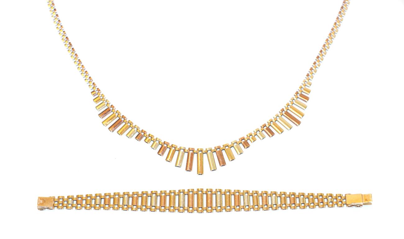 A 9 carat tri-coloured gold necklace, the central section of the necklace of textured undulating