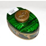 A brass-mounted green glass inkwell, oval, the sides with openwork mounts depicting classical