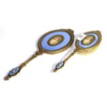 A brass-mounted and enamel hand-mirror and hair-brush, each with light purple enamel and an oval