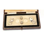 A pair of mother-of-pearl cufflinks and two dress studs, of octagonal shaped button design, cased