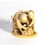 A Japanese carved ivory figure, late 19th/early 20th century, carved to depict two children