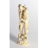 A Japanese carved ivory figure, late 19th/early 20th century, depicting a man standing on carved