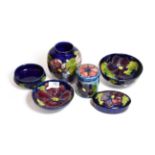 Six Walter Moorcroft Clematis pattern wares, including two bowls, oval trinket box and cover, ginger