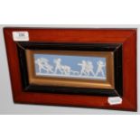 A late 19th/early 20th century framed and glazed Wedgwood Jasper ware plaque, 30cm by 18cm