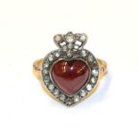 A Victorian garnet and diamond cluster ring, of heart shape design, the heart shaped cahochon garnet