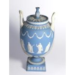 A Wedgwood blue Jasper ware urn and cover decorated in the Classical taste with the Greek muses (