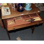 An oak three drawer canteen and contents