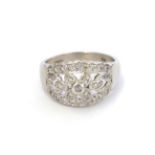 A platinum diamond ring, the central floral cluster flanked by tapered bars set throughout with