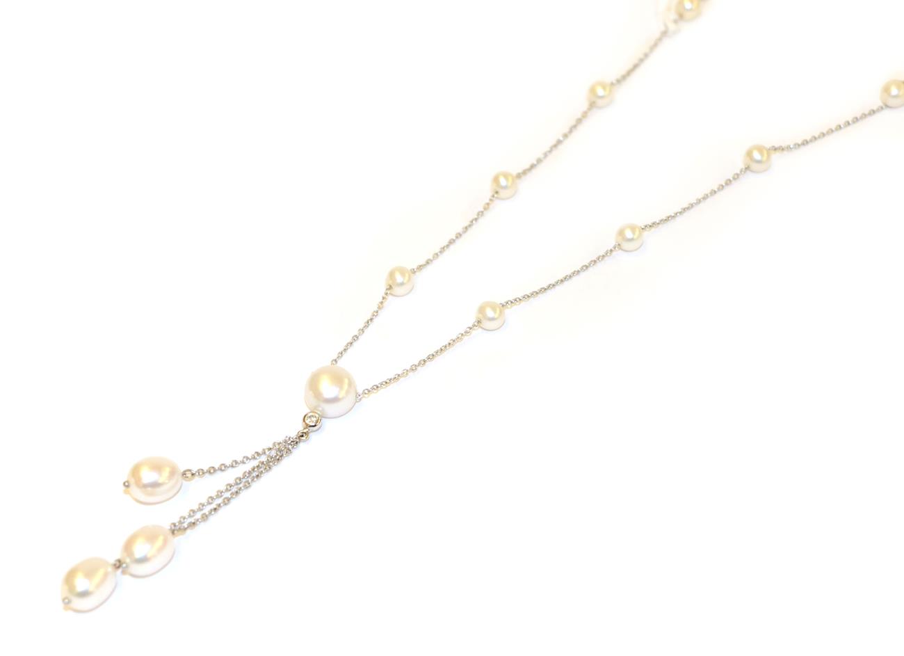 An 18 carat white gold cultured pearl and diamond necklace, the trace link chain interspaced with