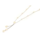 An 18 carat white gold cultured pearl and diamond necklace, the trace link chain interspaced with