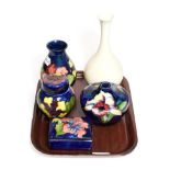 A William Moorcroft vase, 21.5cm (crazed) an Orchid pattern light fitment, 10cm and three Walter