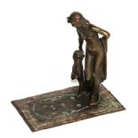 A Bergman Bronze of a young woman with a seated Panther beside her, upon an Islamic rug
