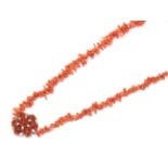 A coral necklace, the branch coral knotted to a 9 carat gold chalcedony and white stone cluster