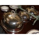 A graduated set of silver plated meat domes with beaded handle and rim, each engraved with a