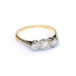 A diamond three stone ring, the graduated round brilliant cut diamonds in white claw settings, to