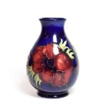 A Walter Moorcroft Anemone pattern vase, on a blue ground, impressed marks, and green painted