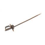 A French diamond sword stickpin, the hilt set throughout with rose cut diamonds, in white claw