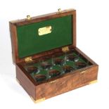 An inlaid and brass mounted boxwood hinged box with fitted interior, housing eight numbered etched