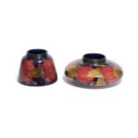 Two William Moorcroft Pomegranate pattern vases, on blue grounds, screw necks, impressed marks,