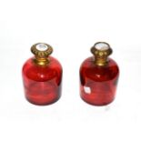 Two brass-mounted cranberry-glass scent-bottles, each tapering, with differing hinged cover, one