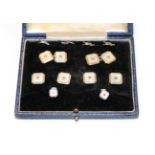 A cased Art Deco mother-of-pearl and diamond dress stud and cufflink suite, comprising four buttons,