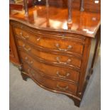 A reproduction mahogany serpentine fronted four height bachelors chest with dressing slide, 71cm